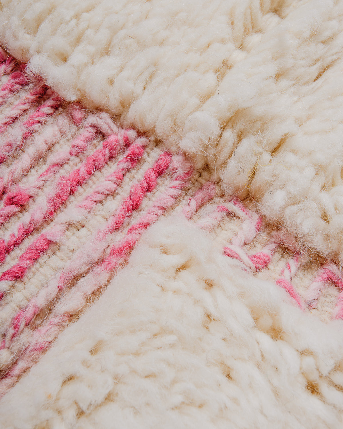 Detail of wool pile and embroidered design of Berber rug.